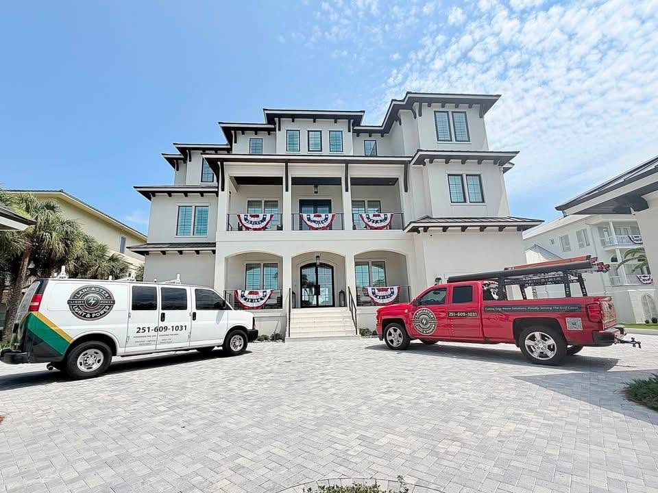 Large custom coastal home in Orange Beach with the Lancaster Light and Power van and truck parked out front