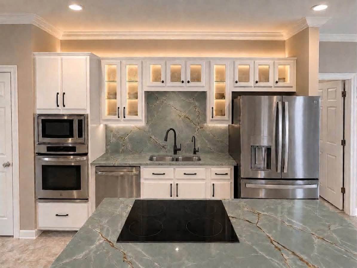 Proposed lighting design for the same kitchen — glass-front cabinets glowing with interior lighting, under-cabinet LED strips, and a green marble backsplash and island